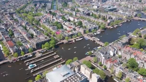 Amstel nehri Amsterdam şehir merkezi, güneşli bir günde kanallarda teknelerle son sürat yol alıyor.. — Stok video