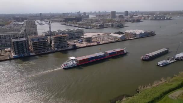 Amsterdam, 9th of May 2021, The Netherlands. Container ship and cargo vessel sailing through the Amsterdams rijnkanaal. — Stock Video