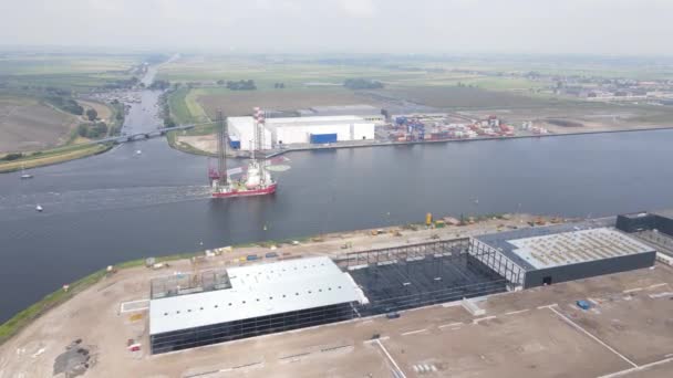アムステルダム西港、オランダを航海する上にクレーン付きの海上プラットフォームの空中ドローンビュー. — ストック動画