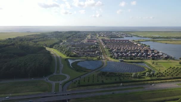 Modern innovative residential area in Almere, along the waterside, including solar panel field. The Netherlands, Flevoland. — Stock Video