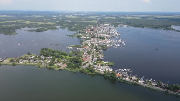 Loosdrecht Loosdrechtse Plassen aerial drone view on a summer day houses and road dyck road running through the water. — Stock Video