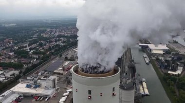 mokestack chimney at power plant in Mannheim Germany. Coal fired power plant. Industrial pollution. Energy production. Aerial video. Close up of smoke.