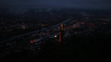 Trier, The Marian Column overlooking the city. Panoramic view at night. Aerial drone video.