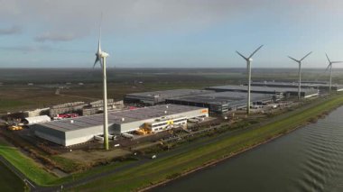 Moerdijk, Province of North Brabant, The Netherlands, November, 17, 2025: Aerial view of the large, modern DHL sorting and distribution center located on the Dordtse Kil industrial zone in Dordrecht, Netherlands. The complex symbolizes large-scale