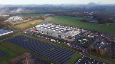 Aerial drone overview of the new data center in Winschoten, Netherlands, highlighting the modern facility, solar panels, and commitment to sustainable AI and cloud infrastructure.