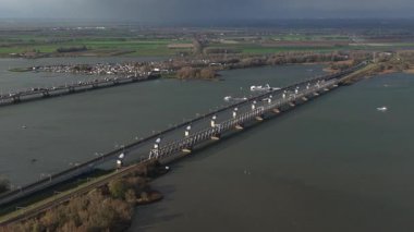 Aerial drone video of the Hollandsch Diep Bridge, Derde Moerdijkbrug, the longest railway bridge on the HSL South line connecting the Netherlands and Belgium. The image highlights the modern rail infrastructure spanning the vast Dutch water. Aerial