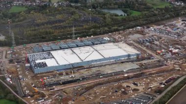 Exterior overview of a large scale artificial intelligence data center undergoing construction in Farciennes, Belgium. This video captures the development phase of a mega investment in digital infrastructure, symbolizing global technology growth and