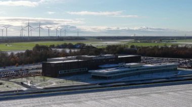 Aerial drone video of the modern Ommelander Hospital Groningen main facility in Scheemda, Netherlands, showcasing the energy-efficient architecture in a winter landscape.