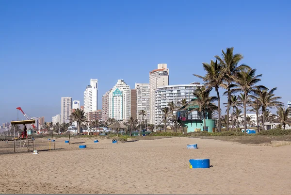 Yellow Surf Ski Blue Concrete Garbage Bins on Beach — Stock Photo, Image