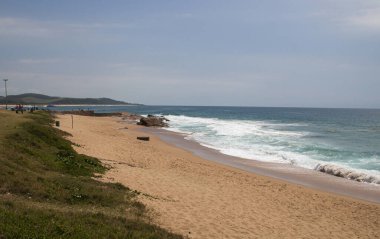Waves breaking on rocks of beach shoreline