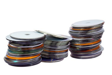 Three Stacks of Colorful Compact Discs on White clipart