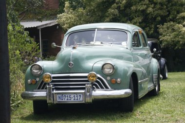 Green Vintage Oldsmobile Car Displayed at Show clipart