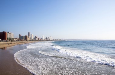 People on Addington Beach Against Durban City Skyline 
