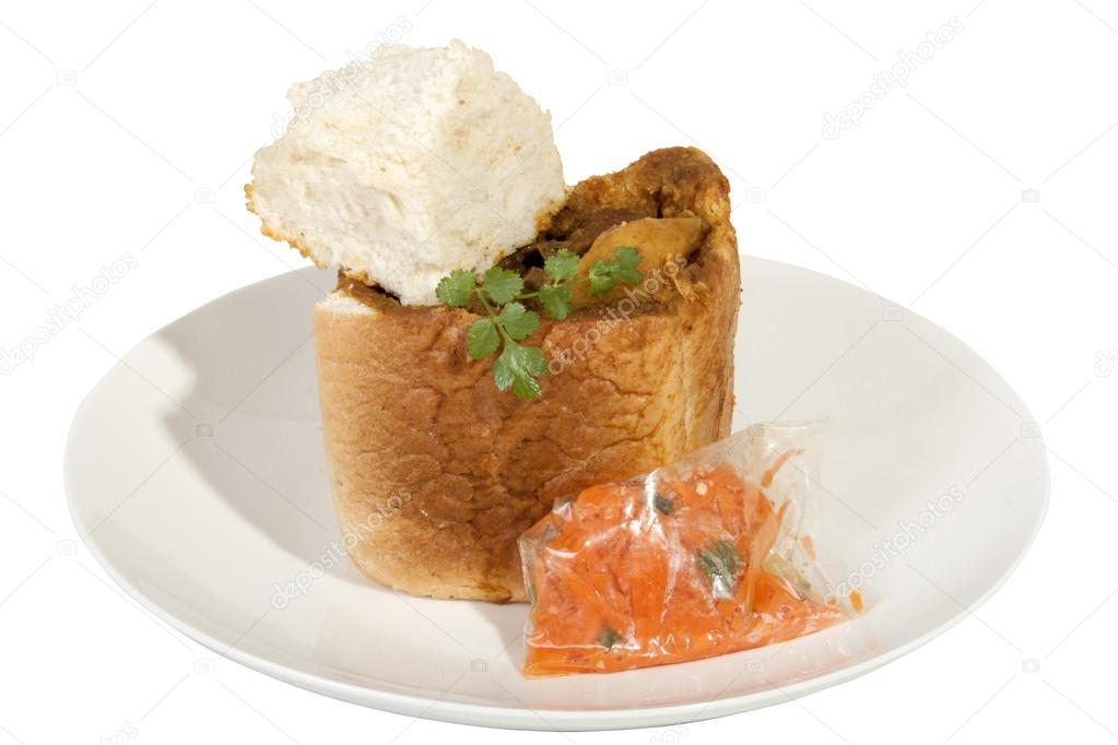 Takeaway Bunny Chow Served with Carrot Sambal and Dhunia