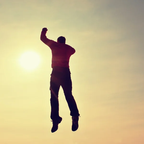 Flying man. Young man falling down on sky background.