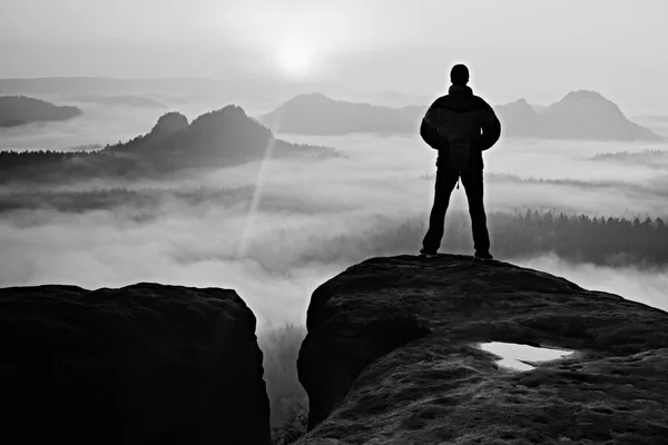 Homem em pico de pedra de arenito no parque nacional Saxônia Suíça observando a Sun. Belo momento. — Fotografia de Stock