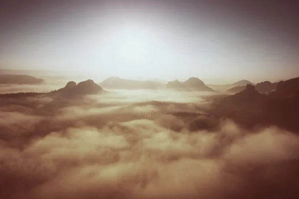 Fantástico amanecer de ensueño en la cima de la montaña rocosa con vistas al valle brumoso —  Fotos de Stock