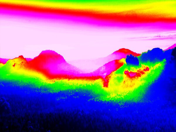 Infrared scan of rocky landscape, pine forest with colorful fog, hot sunny sky above. Amazing thermography colors.