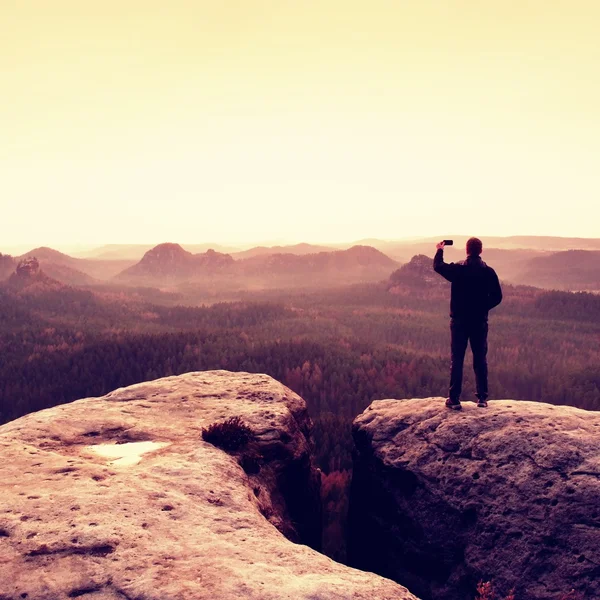 Man photography with phoneof  dreamy hilly landscape, spring orange pink misty sunrise in a beautiful valley — Stock Photo, Image