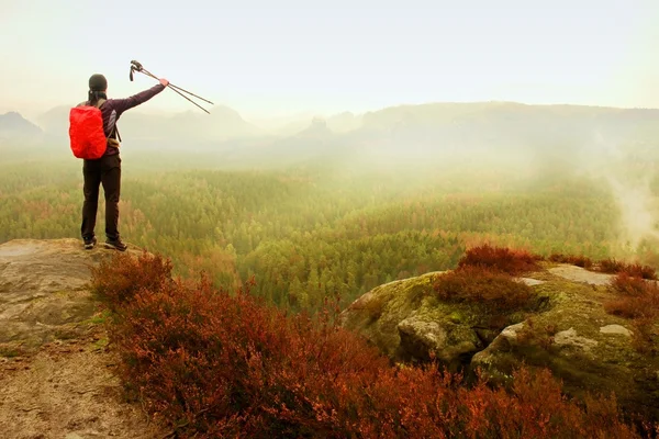 Alone adult backpacker with poles in the air,  open view on mountain valley, misty rainy day — Stock Photo, Image