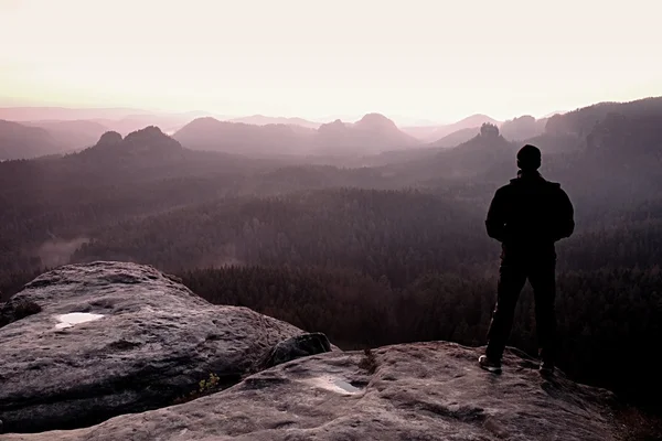 Man on sandstone rock watching to Sun. Beautiful moment of spring morning. — Stock Photo, Image