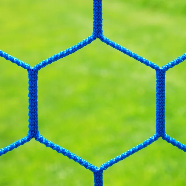 Blue crossed soccer football in goal net, thin rope