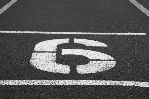 Number six. White athletic track number on red rubber racetrack, texture of racetracks in stadium — Stock Photo, Image