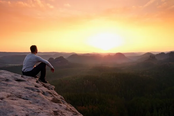 Tourist watching sunrise above  misty hilly valley — Stock Photo, Image