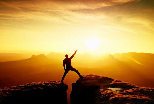 Slim tourist gesture triumph on sharp peak of rocks — Stock Photo, Image