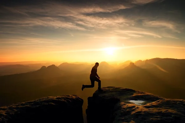男をジャンプします。若い男は、断崖の間のステップ. — ストック写真