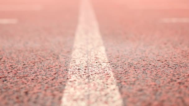 Raining on racetrack in campus stadium. Water on ground.  Red texture of running racetrack under mirror water level, red rubber in outdoor stadium. — Stock Video