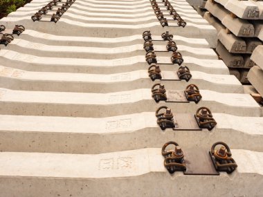 Sleepers stock in railway depot. Concrete railway ties stored for reconstruction  clipart