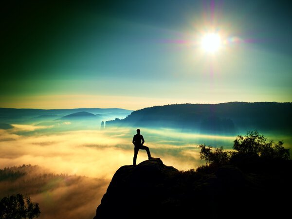 Man silhouette on the sharp peak. Satisfy hiker enjoy view. 