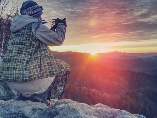 Nature still photography photographer woman with professional slr camera taking picture of fall daybreak. Abstract filter.