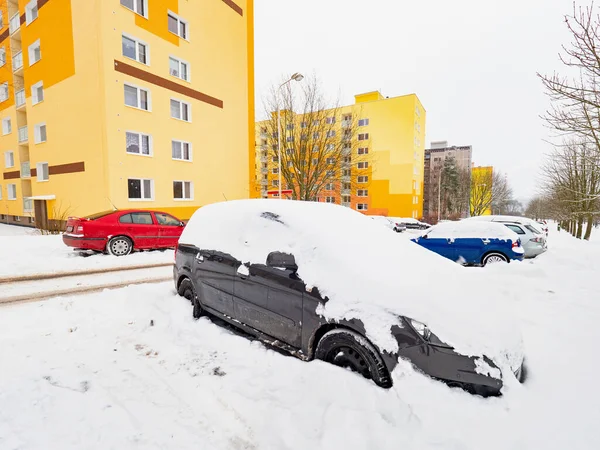 Parked car trapped in huge snow cover. The car was covered with snow. Car under the snow