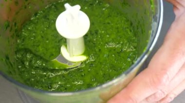 Ispanak ya da kabın içinde doğranmış bitki. Sağlıklı yeşil organik gıda hazırlanıyor. Ev yapımı yemek, blender bıçağı ve kase..