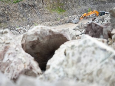 Ağır taş ocağı yükleyicisi açık çakıl madeninde çalışıyor. Taş ocağında buldozer inşaatı