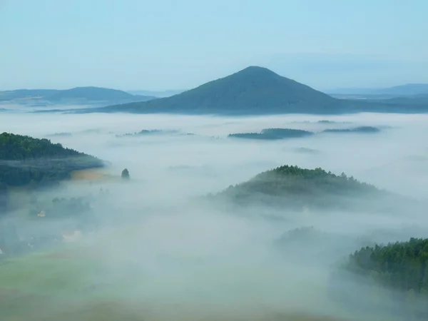 Paisaje nublado de otoño. Ambiente de ensueño, la niebla está temblando entre picos de colinas. Mañana de otoño fría y de ensueño en el parque de la Suiza bohemia . —  Fotos de Stock