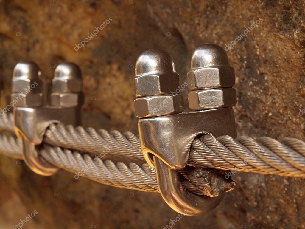 Climbers way. Iron twisted rope fixed in block by screws snap hooks. The  rope end anchored into sandstone rock. — Stock Photo © rdonar #53942827
