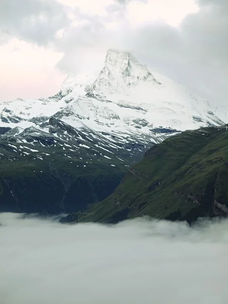 Misty sharp peaks of Alps mountains above heavy fog in valley. First snow covered mountains — Stock Photo, Image