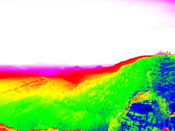 Fantastic infrared scan of rocky  landscape, pine forest with colorful fog