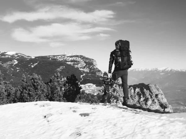 Toeristische in het zwart is permanent op rotsachtige oogpunt en kijken in mistige rocky mountains. Nationaal park Alpen park in Italië. Zonnige winterochtend. — Stockfoto