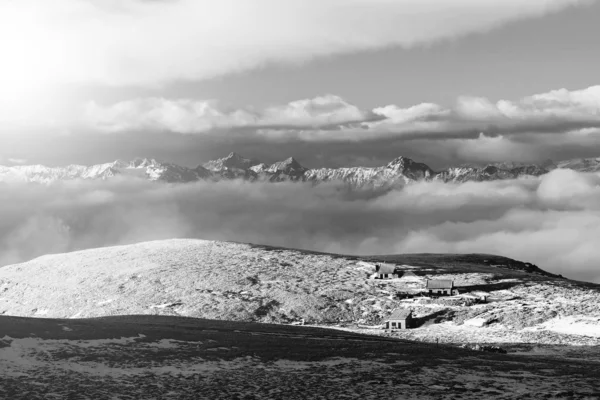 晴れた冬の日の apine 山の岩が多い峰。冷凍ブルーベリーと新雪パウダーの下の岩 — ストック写真