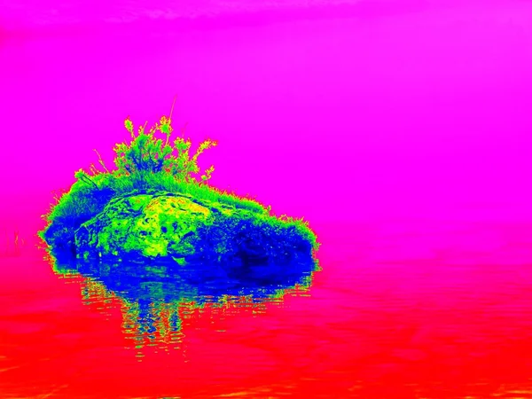 Mountain lake in middle of swamp with small island. Sky in mirror of water level, strange colors of thermography photo. Boulders and water level in shadows of trees. — Stock Photo, Image