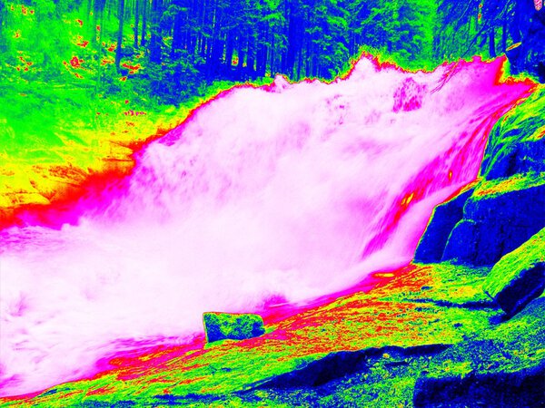 Foamy water level of waterfall, curves between boulders of rapids. Water of mountain river in infrared photo. Amazing thermography. 