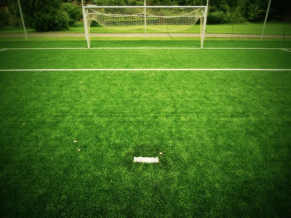 Fútbol patio vista del campo de hierba, puerta al final. Detalle de una esquina en un campo de fútbol. Hierba plástica y caucho negro finamente molido . —  Fotos de Stock