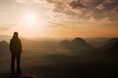 Hiker stand on the sharp corner of sandstone rock in rock empires park and watching ove clipart