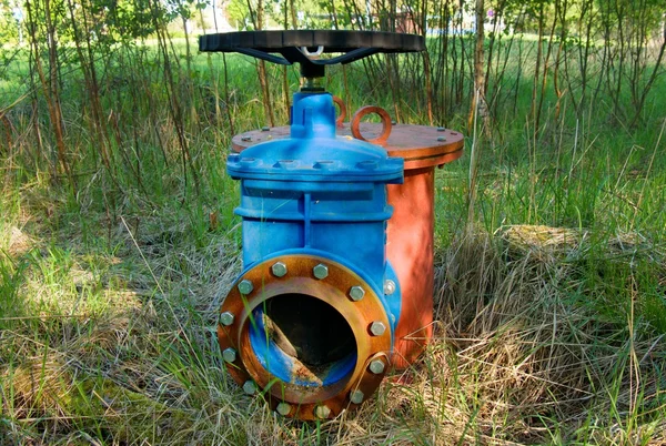 Old expansion pipe of drink water pipes joined with new blue valve and new blue joint members. New dump valve.  Extreme kind of corrosion, metal corroded texture. — Stock Photo, Image