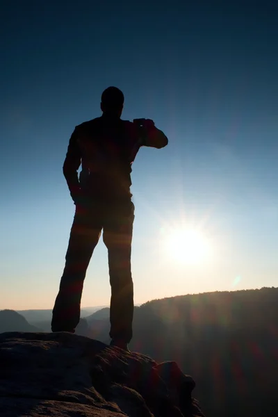 Ein Mann hat seine Hände auf den Hüften. Sportler-Silhouette in der Natur bei Tagesanbruch. — Stockfoto