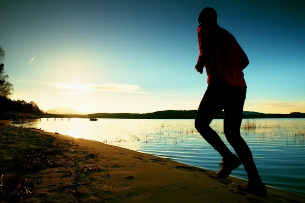 Running man. Male runner jogging during the sunrise on sandy beach — Stock Photo, Image